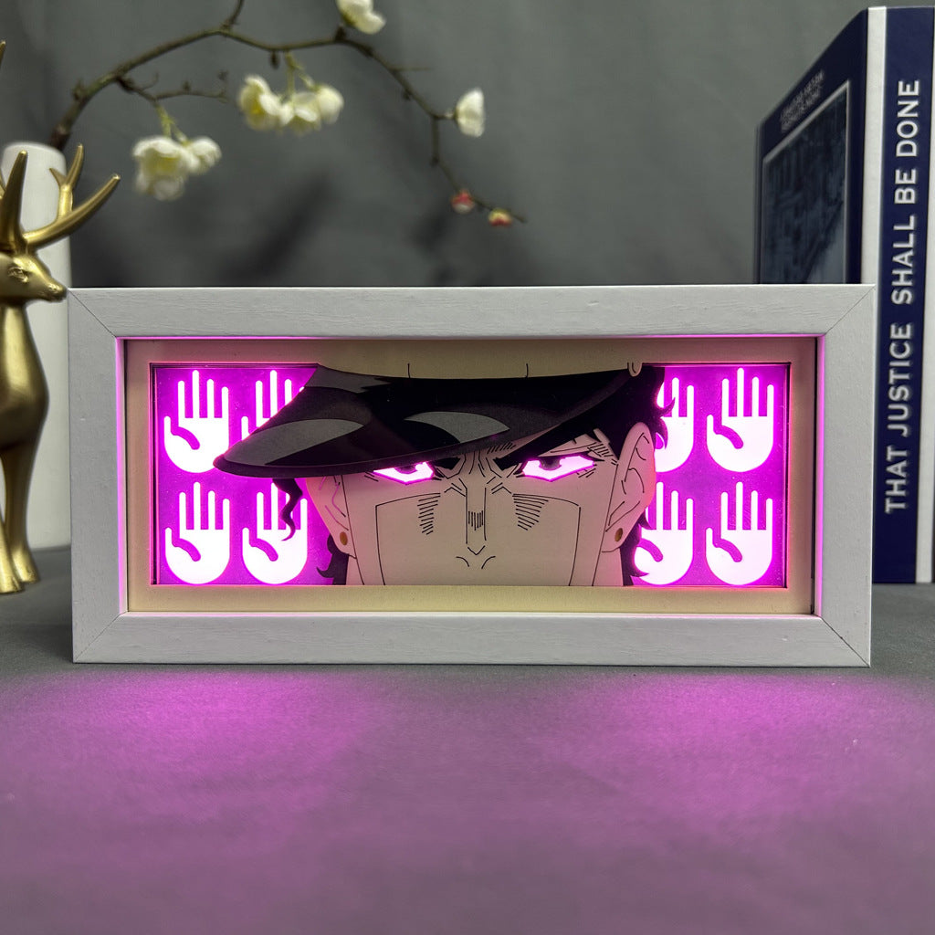 A 16-color adjustable LED JoJo’s Bizarre Adventure Anime Light Box showcases Jotaro Kujo with an intense expression and glowing pink hand symbols. Nearby, a decorative deer sculpture and the book &quot;That Justice Shall Be Done&quot; complete the scene.