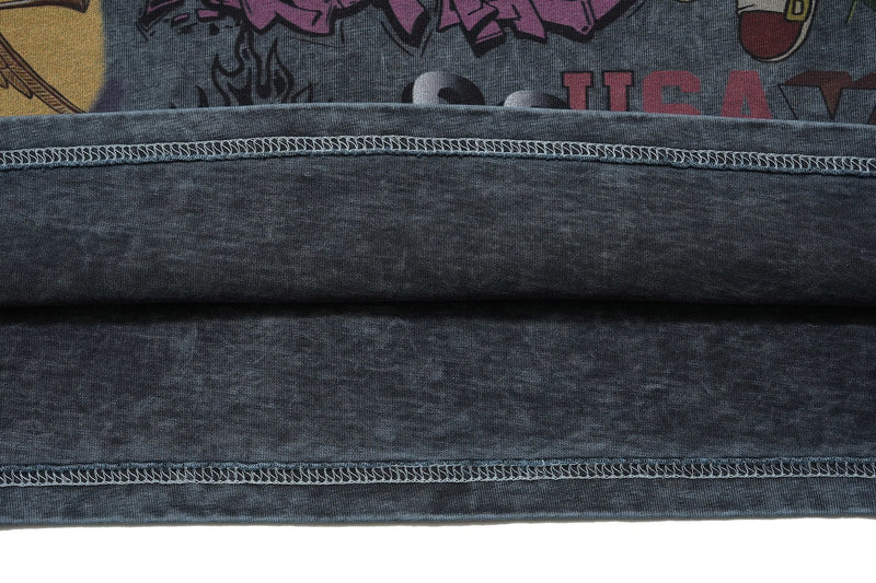 Vintage wash graphic tee with visible seam details and partial colorful Sacred Chaos print on dark fabric