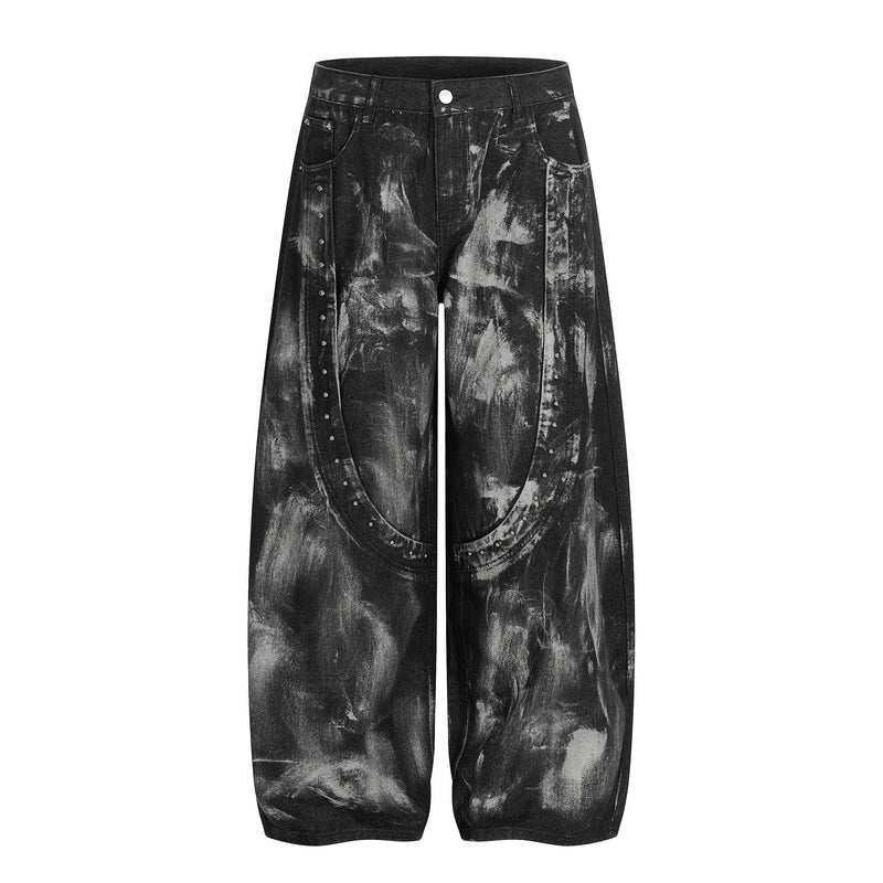 Front view of black wide-leg jeans with painted wash and studded crescent seam details