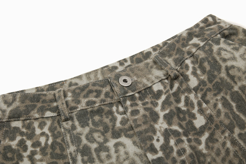 Close-up of waistband button and topstitching on leopard print barrel pants