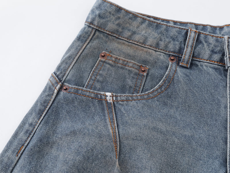 Close-up of the front pocket area with rivets, stitching, and distress detail