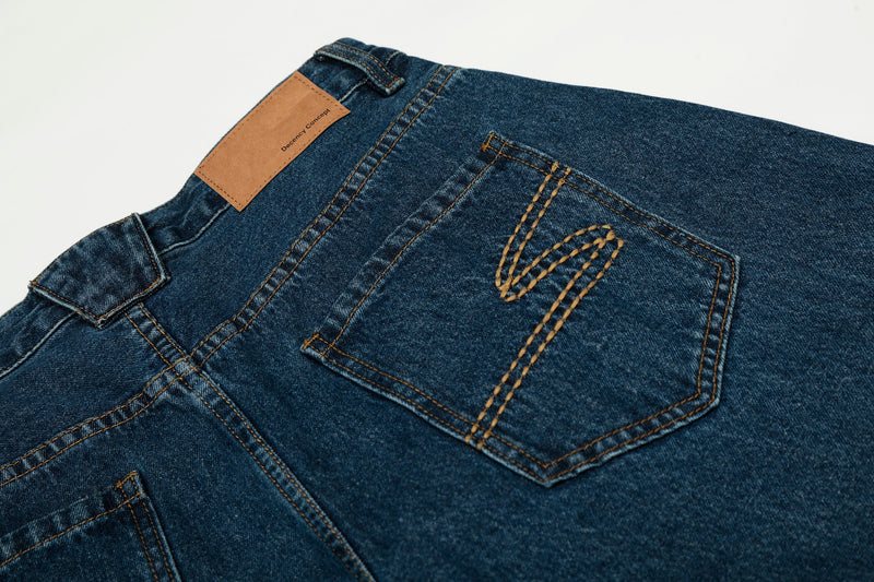 Close-up of the back pocket and tan label on deep indigo jeans