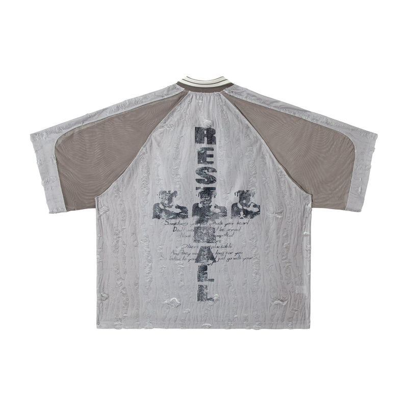 Oversized distressed mesh patchwork tee with beige panels, vertical graphic print, and textured light gray fabric