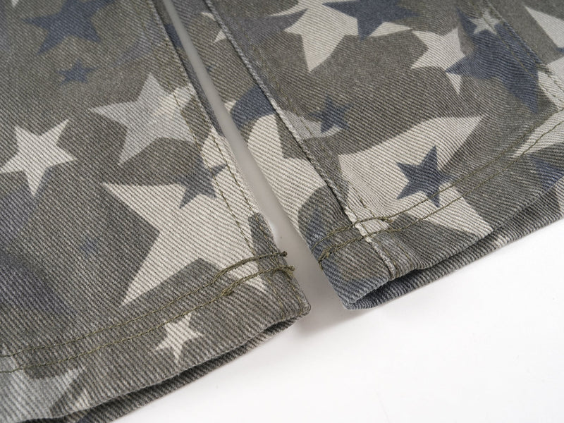 Close-up of pant hems with stitched edges and star print denim