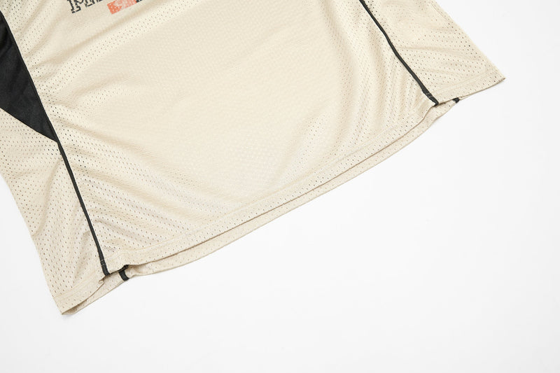 Beige mesh jersey hem with black side panel and piping detail on white background