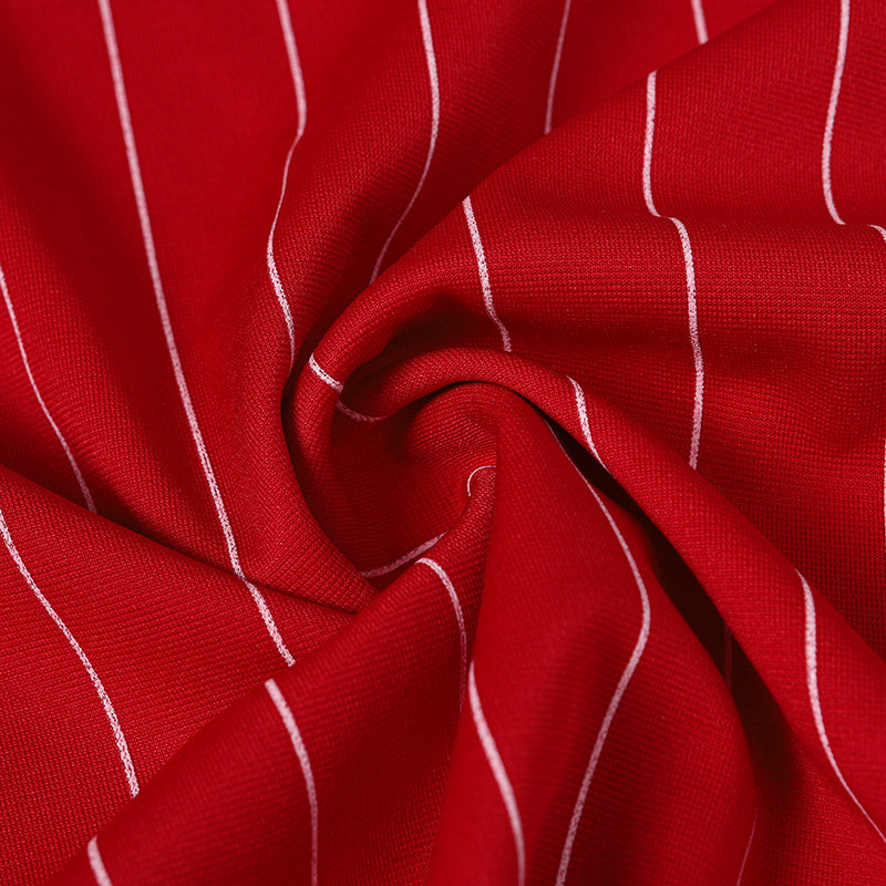 Red pinstripe soccer jersey fabric with white vertical stripes and textured knit close-up