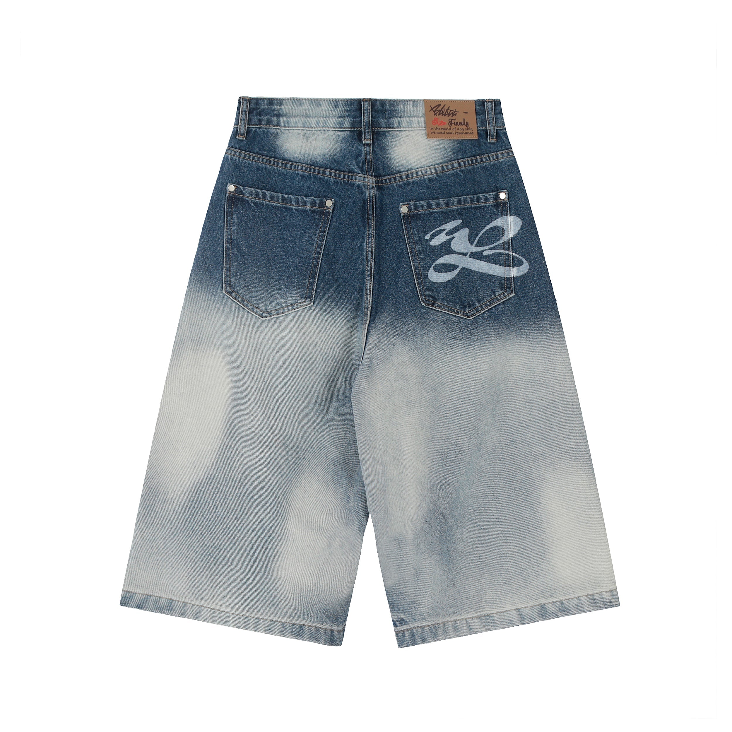 Back view of Omirad bleached distress wide-leg denim shorts with spray script graphic on right back pocket