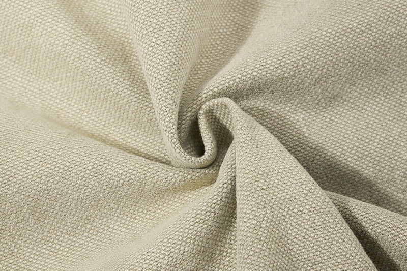 Close-up of textured olive green cotton denim fabric