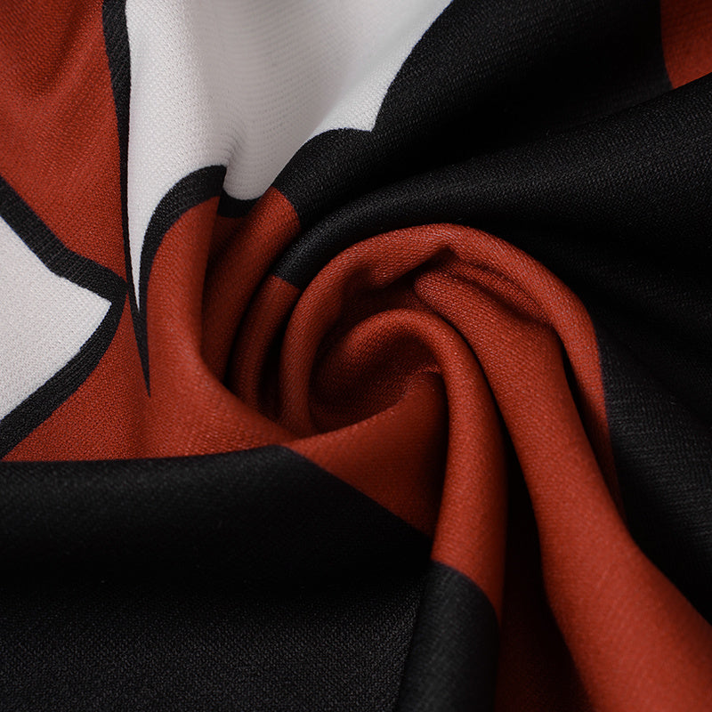 Close-up of black, red, and white striped football jersey fabric with a bold flame-inspired athletic design