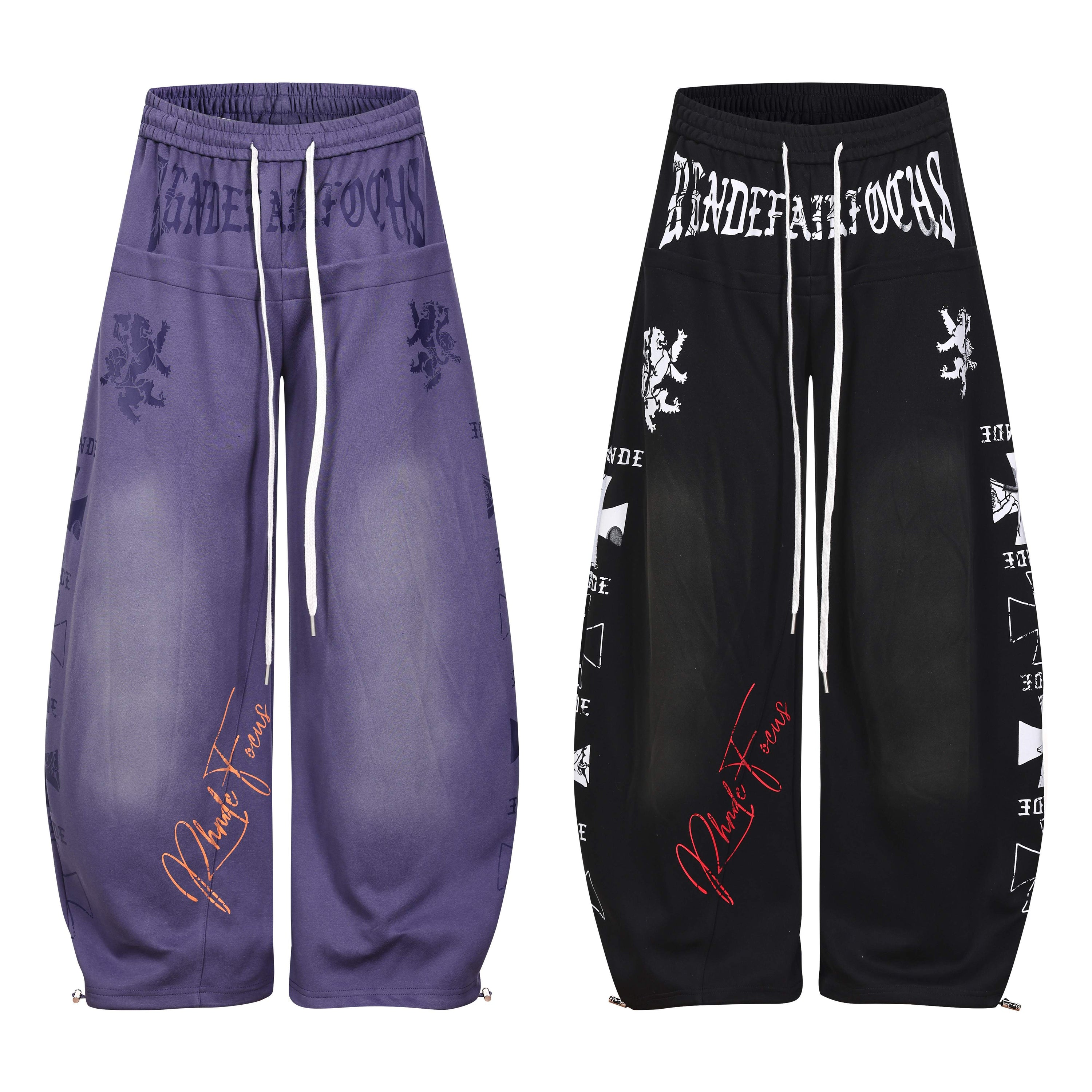 Omirad gothic script wide-leg pants in washed purple and black with heraldic lion prints and ankle zip detail