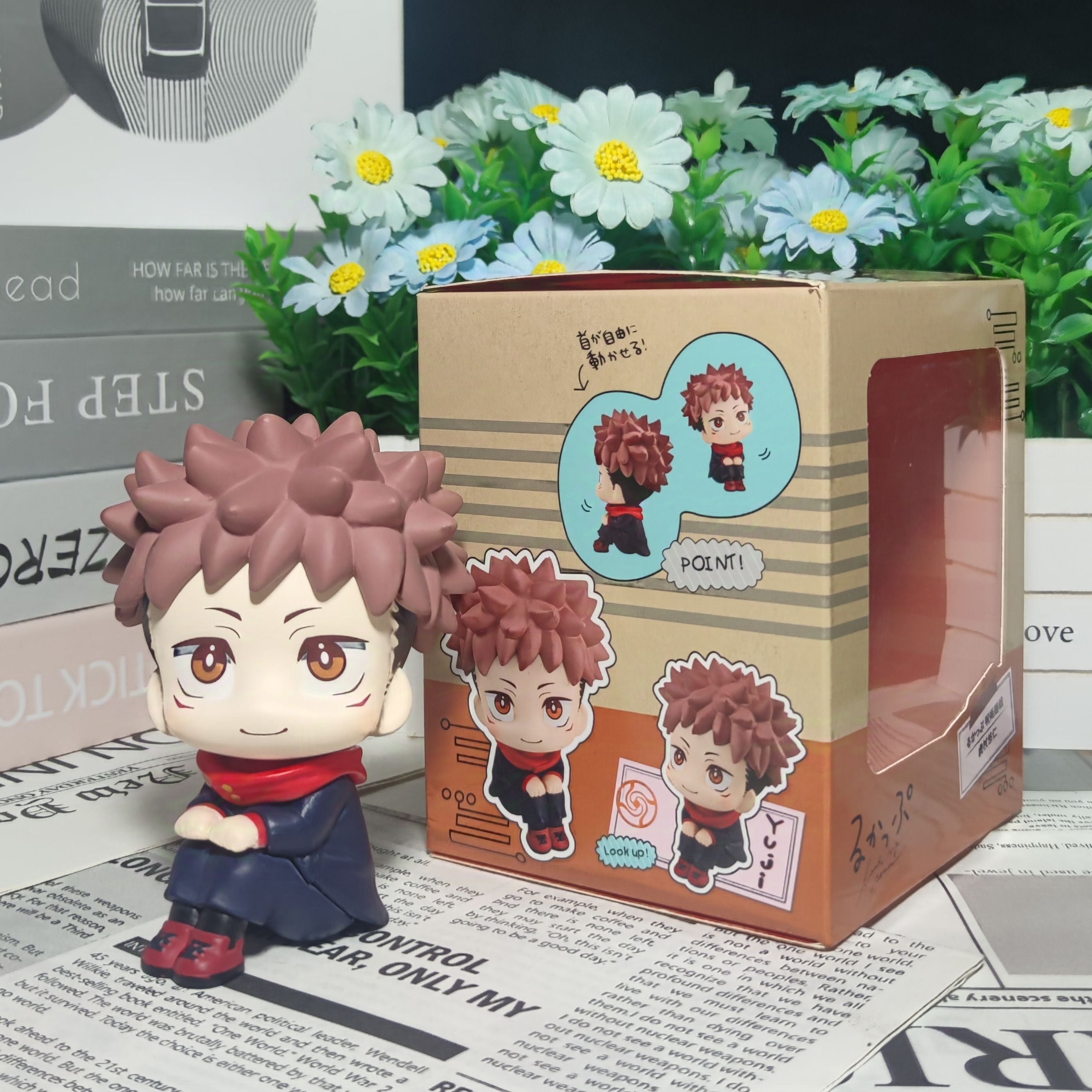 The Itadori Yuji Anime Figure by Jujutsu Kaisen features a 12cm static pose figure with spiky brown hair, perfect for collectors. The box displays dynamic character illustrations, set amidst white and yellow flowers on a patterned background.