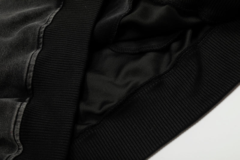 Close-up of black hoodie lining and ribbed trim at the hem