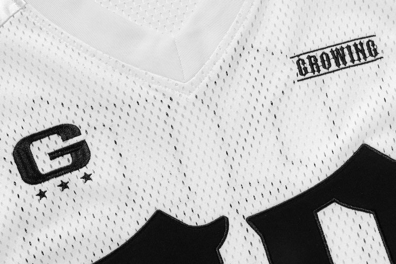 Close-up of front chest on white mesh jersey showing G and GROWING embroidery