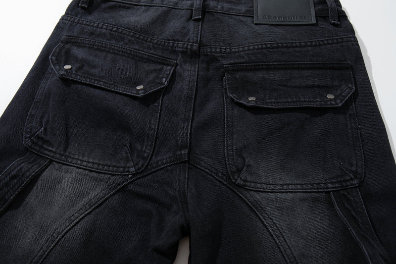Back pocket close-up on black cargo jeans with flap pockets and stitched seams