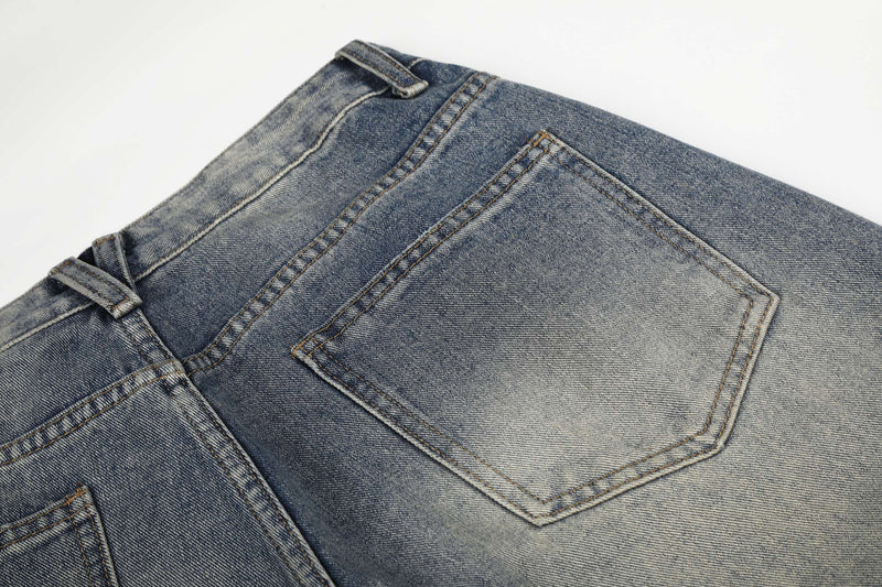 Close-up of back pocket on light faded blue wide-leg jeans