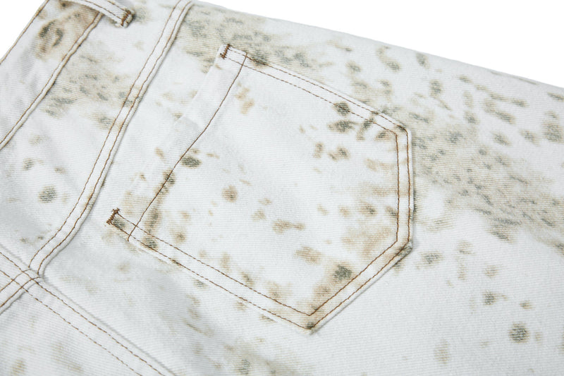 Close-up of back patch pocket on white splatter-wash barrel jeans