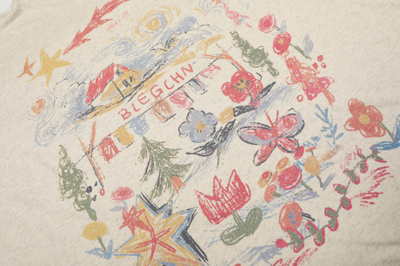 Close-up of hand-drawn front print on cream long sleeve tee with stars and flowers