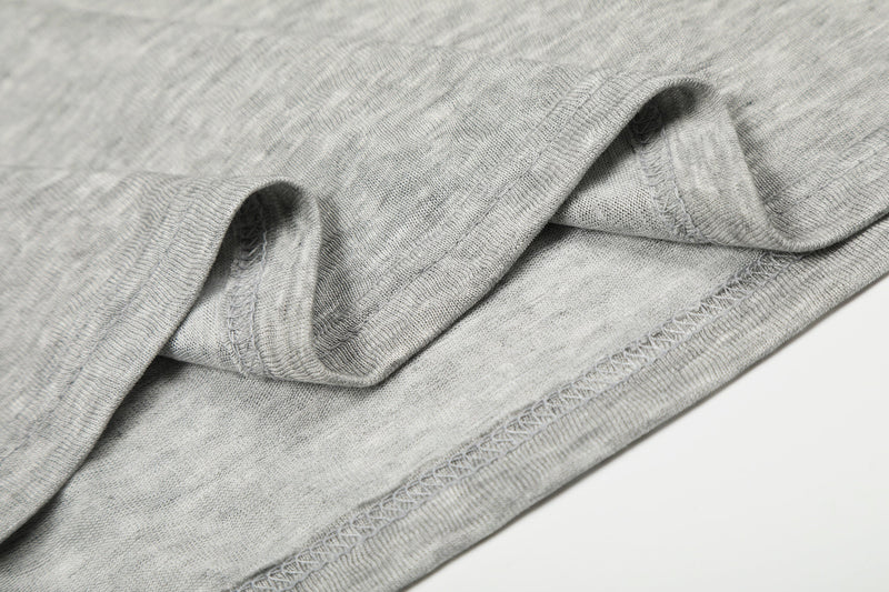 Close-up of sleeve cuff and stitched hem on gray tee