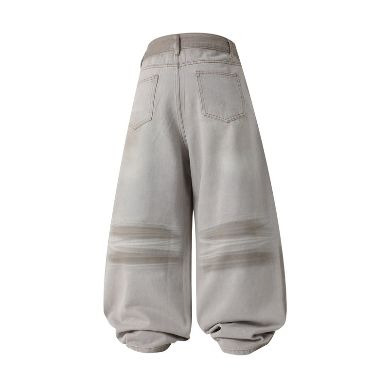 Back view of light gray balloon-fit denim pants with wide legs and faded wash
