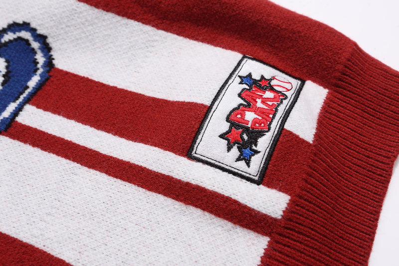 Close-up of embroidered patch on red and white striped knit sweater sleeve
