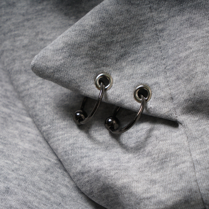 Close-up of hood eyelets with black drawstring rings on gray hoodie