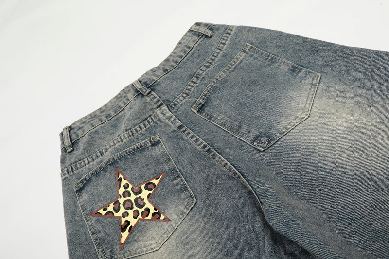 Back view close-up of blue jeans showing leopard star patch on the back pocket