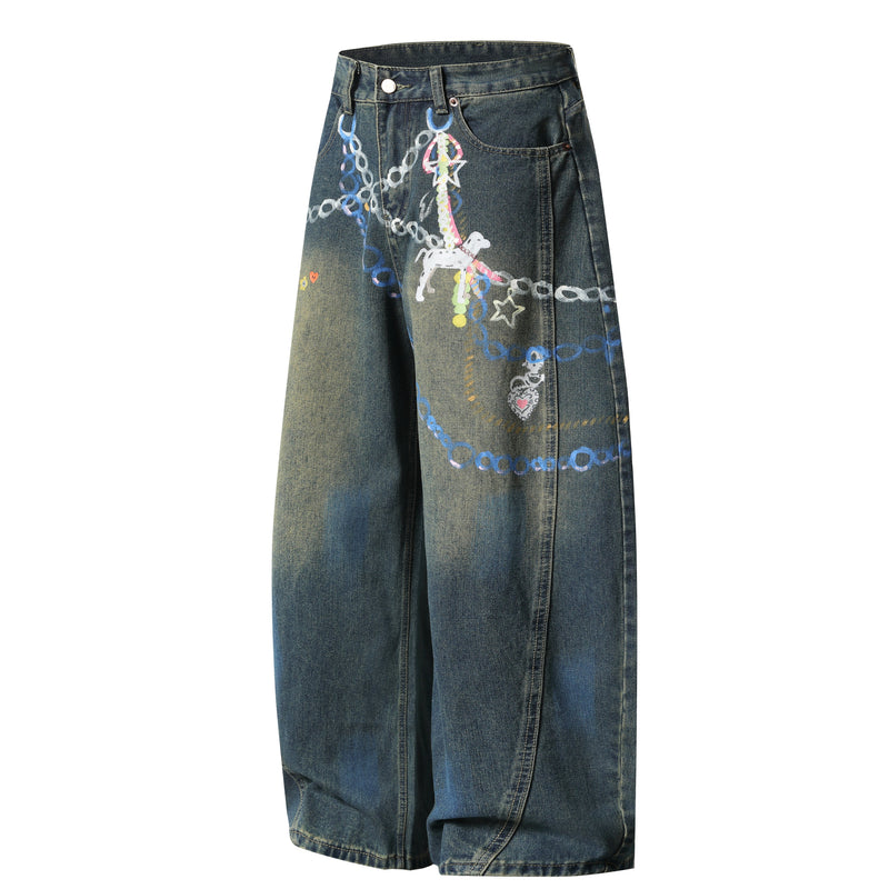 Angled front view of dark wash wide-leg denim pants with colorful painted graphic