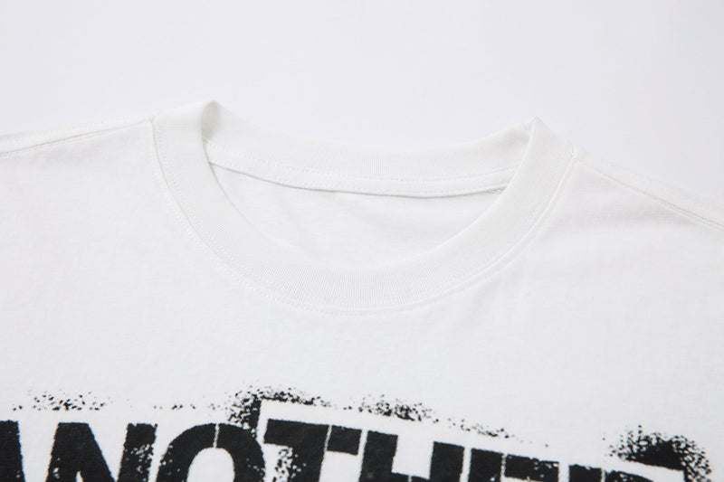 Close-up of white ribbed crewneck collar and upper front print edge