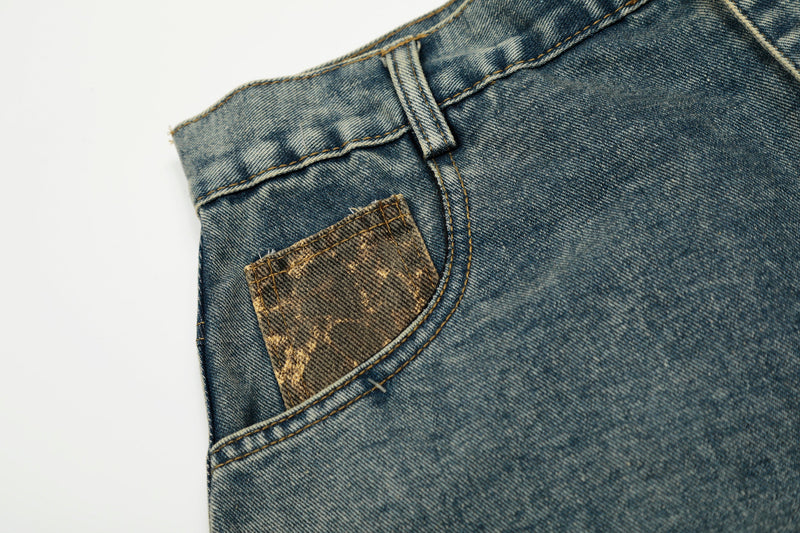 Close-up of leopard-print pocket detail on blue denim jeans