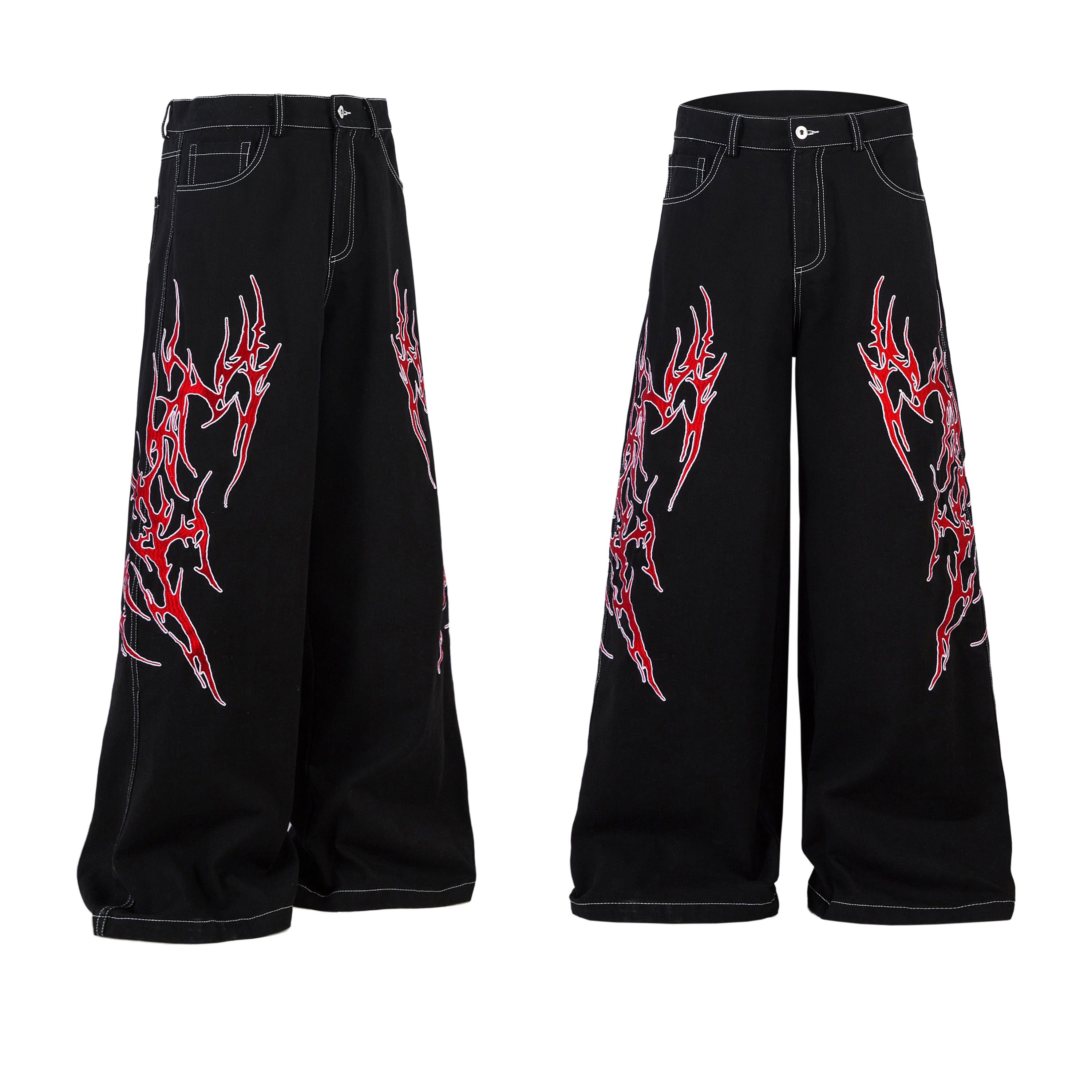 Black wide-leg denim jeans with red and white tribal flame embroidery on both legs, shown front view