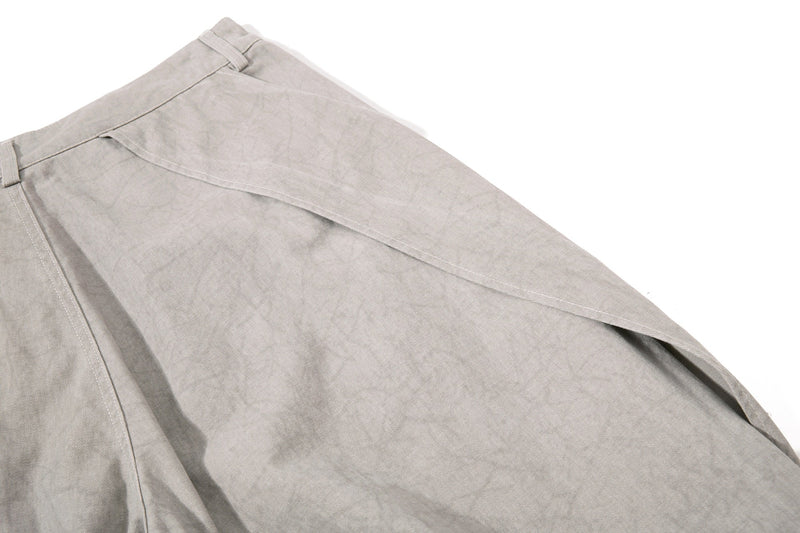 Light beige denim back hip close-up with flowing side panel seam