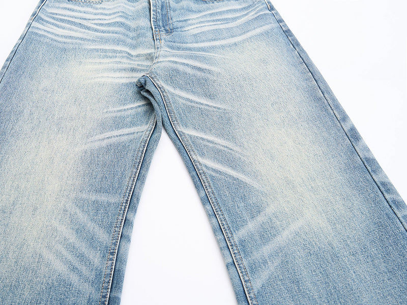 Close-up of wide-leg denim with whiskered wash at the thighs