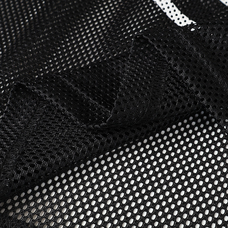Black mesh football jersey fabric with a gothic skull emblem and bold streetwear texture