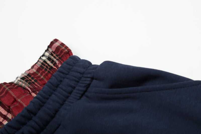 Close-up of waistband edge showing red plaid lining and navy elastic trim
