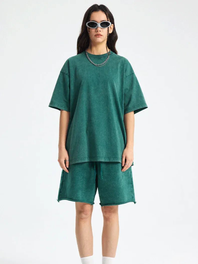 Person wearing a Custom Anime Character Green Washed T-Shirt - Personalized Anime Style Tee, matching shorts, white socks, sunglasses, and a chain necklace, standing against a plain white background.