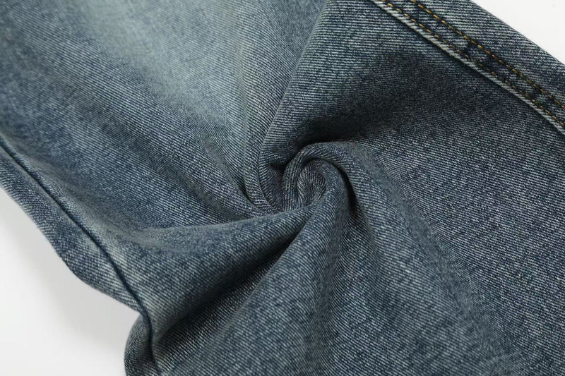 Close-up of folded blue denim fabric with soft faded texture
