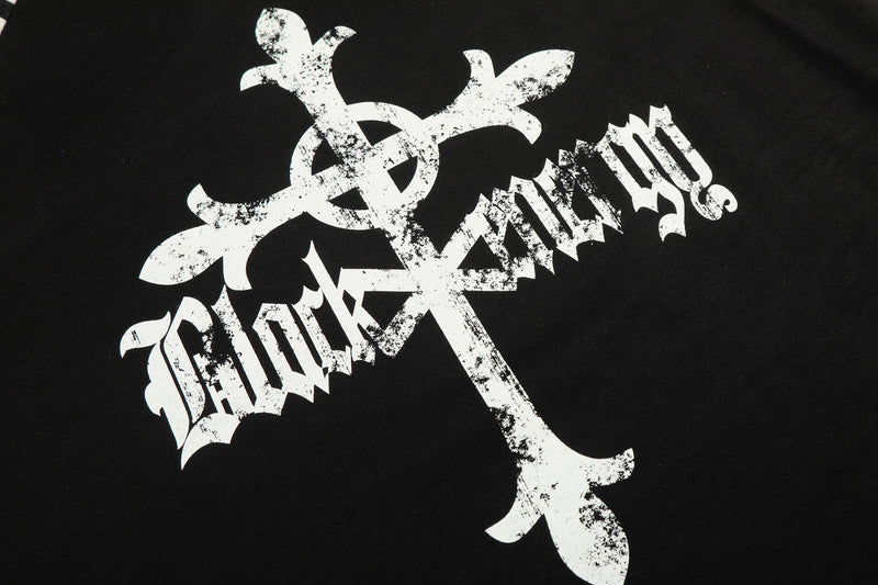 Close-up of large distressed gothic cross graphic on black tee