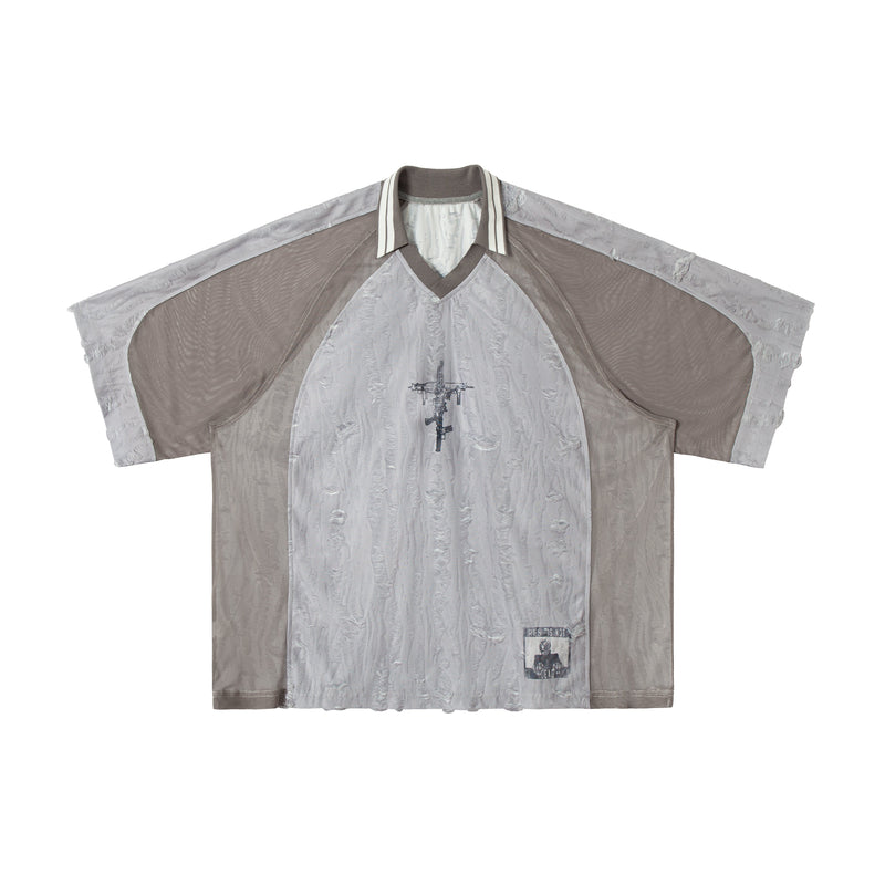 Gray patchwork mesh tee with distressed texture, striped collar, and graphic print on the chest