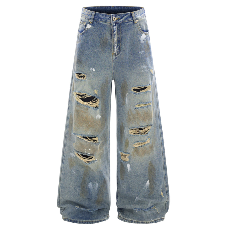 Front view of distressed wide-leg blue jeans with ripped patches and faded wash