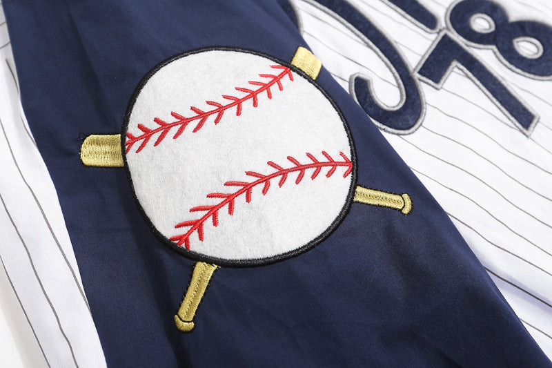 Close-up of embroidered baseball patch with red stitching on navy sleeve panel