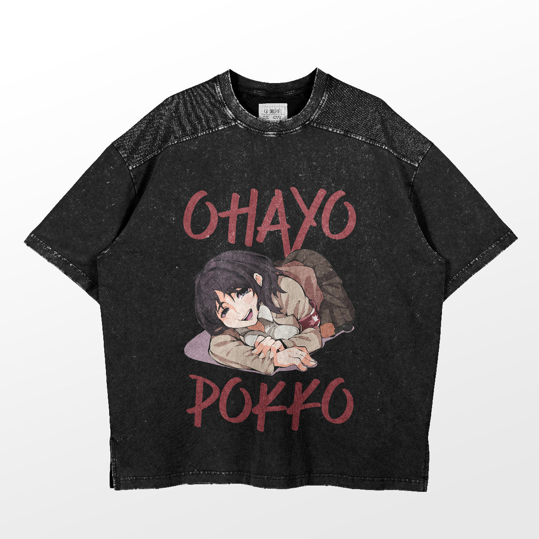 The &quot;Ohayo Pokko&quot; T-shirt from Attack on Titan features a black, faded wash with an anime-style girl lying and smiling, plus bold red text above and below her. It’s perfect for any fan of anime girl T-shirts, combining style with fandom seamlessly.