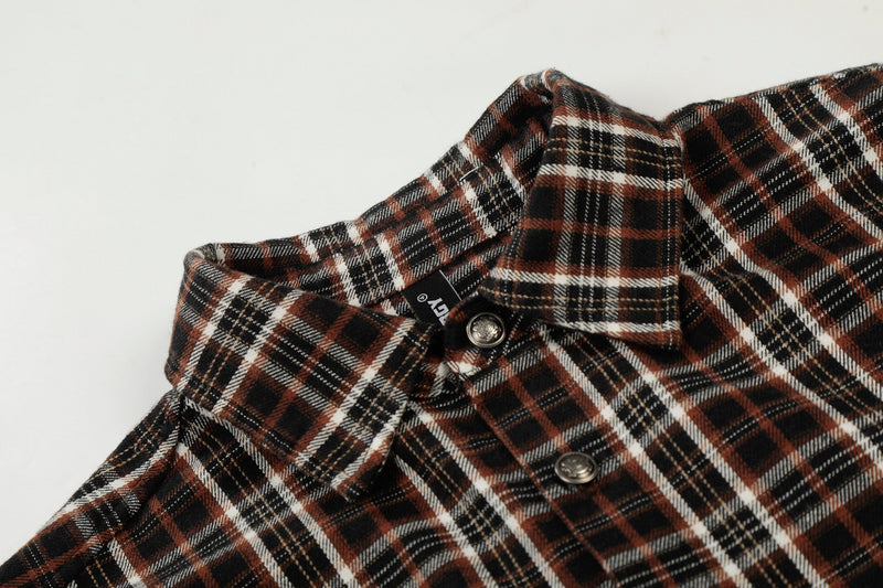 Distressed plaid short sleeve shirt with raw edge details, button front, and black, rust, and white pattern