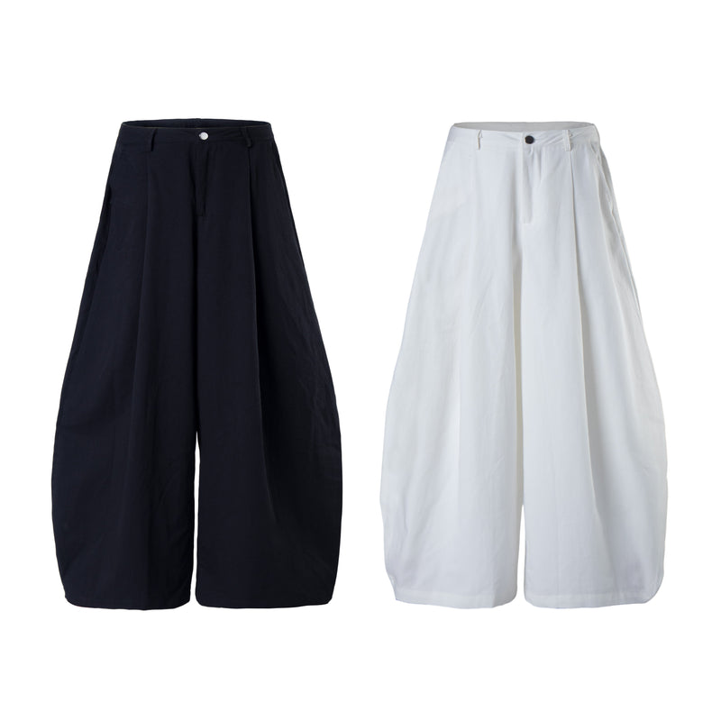 Wide-leg cargo pants in black and white, front view with minimal snap-button waist