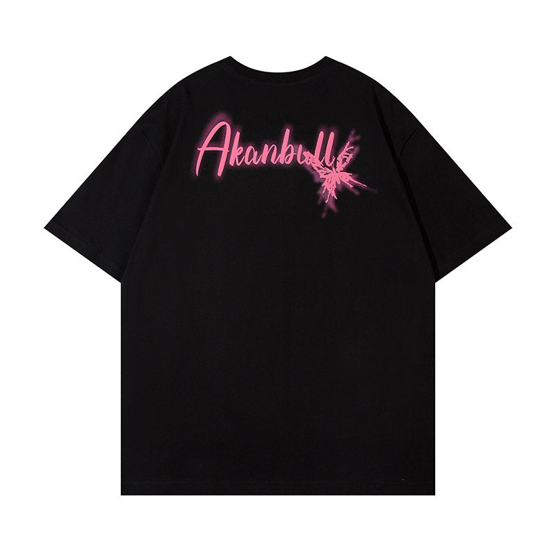 Black oversized streetwear tee with pink graffiti-style chest graphic and splash detail