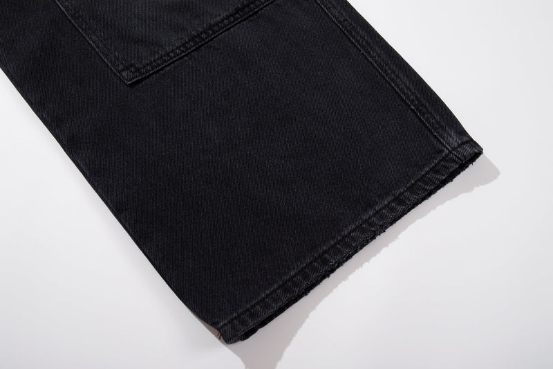 Close-up of hem on black wide-leg denim carpenter jeans
