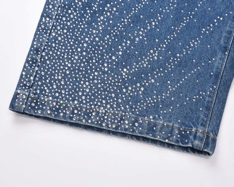 Close-up of blue denim shorts hem with dense rhinestone embellishment