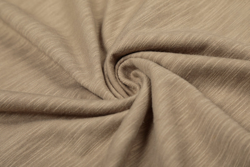 Close-up of gathered brown washed knit fabric with soft drape
