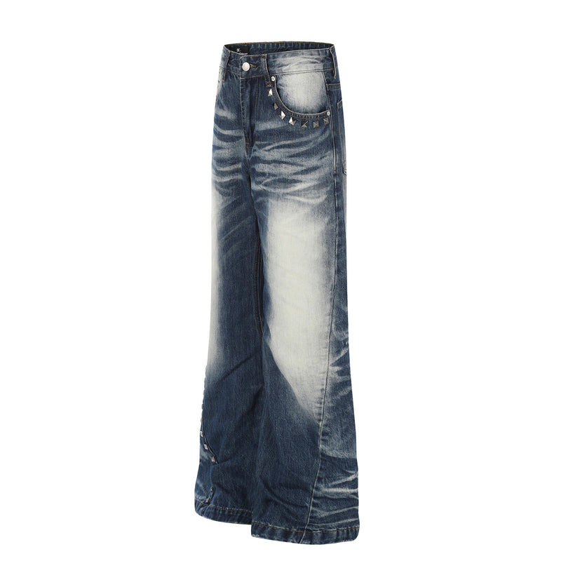 Angled front view of wide-leg vintage wash jeans with studded pocket detail and faded denim