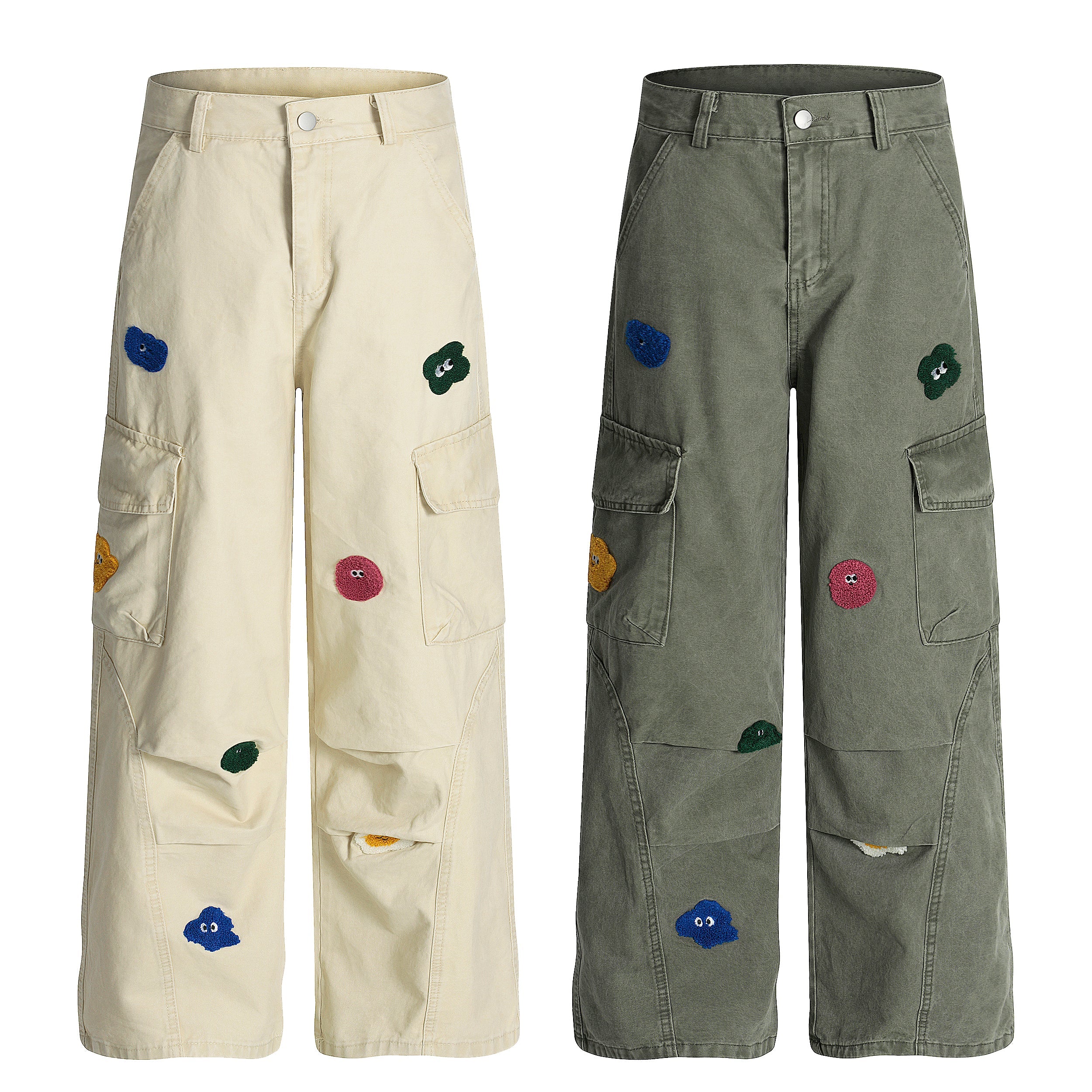 Cream wide-leg cargo pants with multicolor chenille cartoon patches scattered across both legs, front view