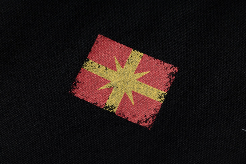 Close-up of red and yellow chest patch on black hoodie